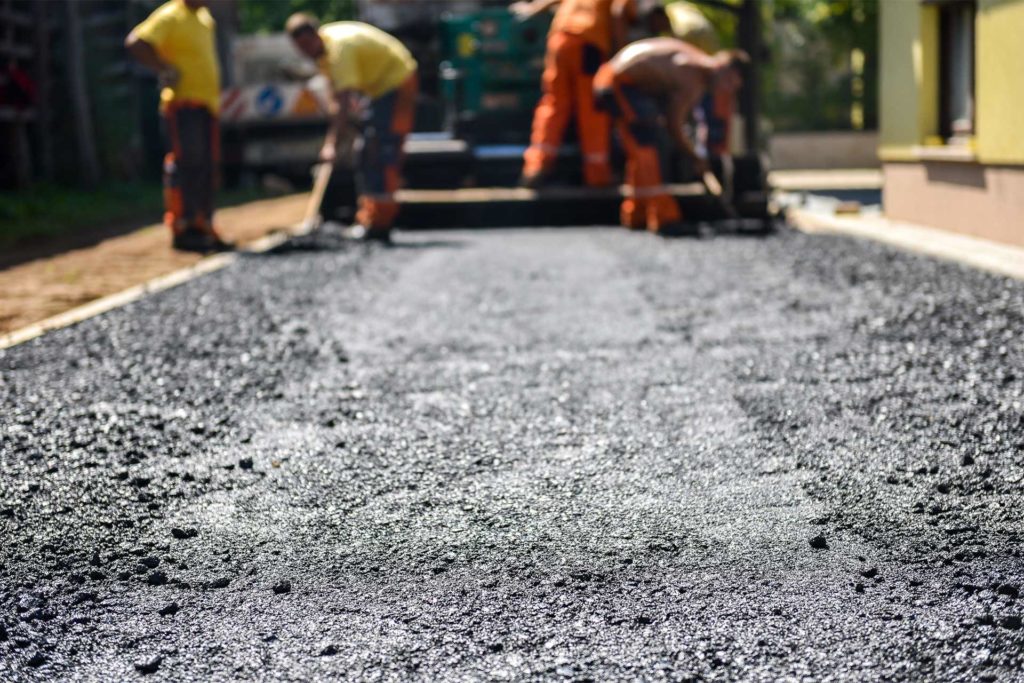 construction workers redoing driveway with concrete for home maintenance